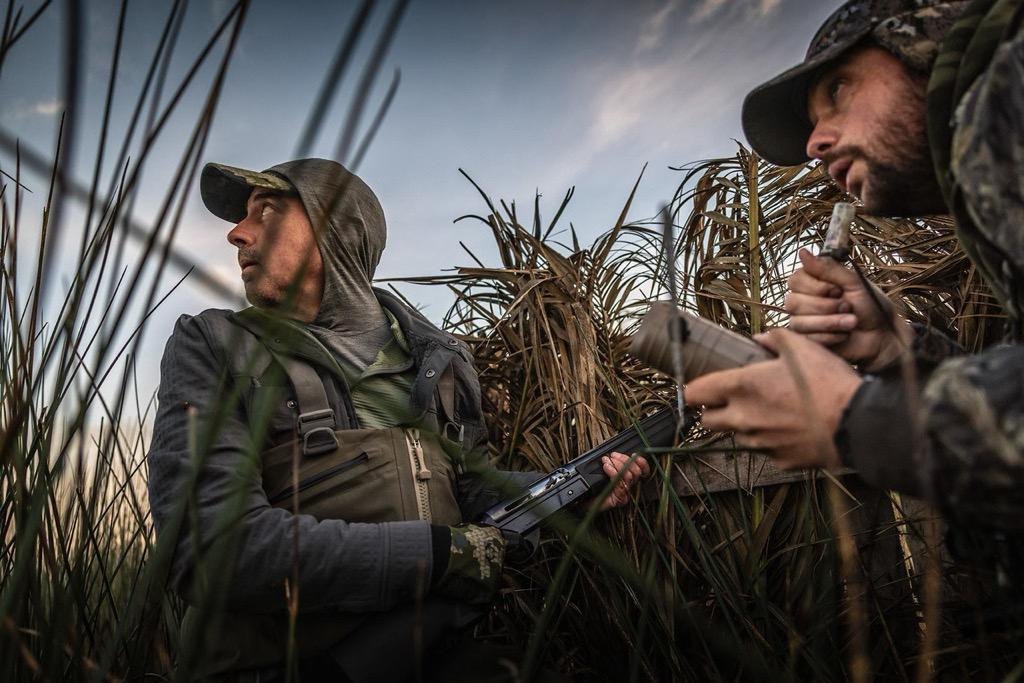 Hunter crouched in the reeds before dawn, waiting on the first flight